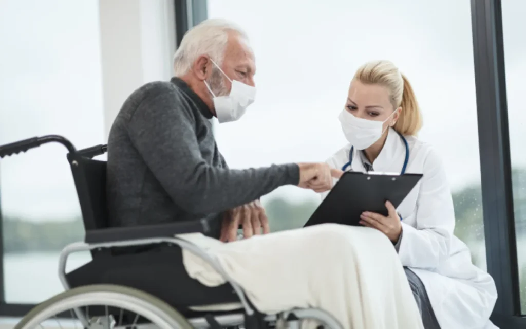 A patient in a wheelchair with a clinician