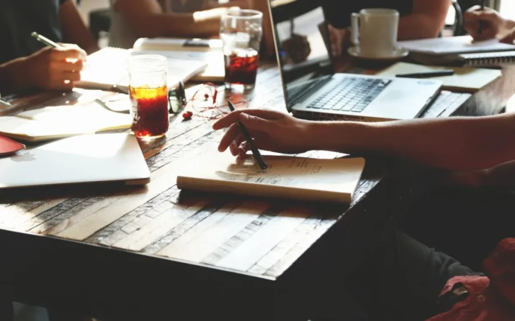 People comparing documents around a table
