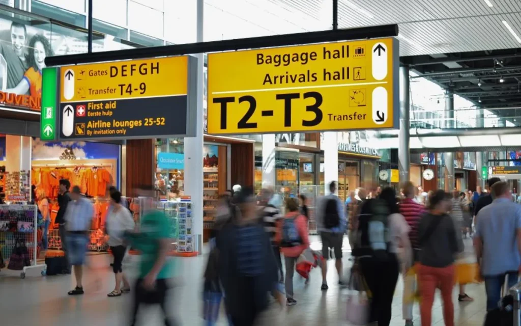 Travellers in an airport arrivals hall