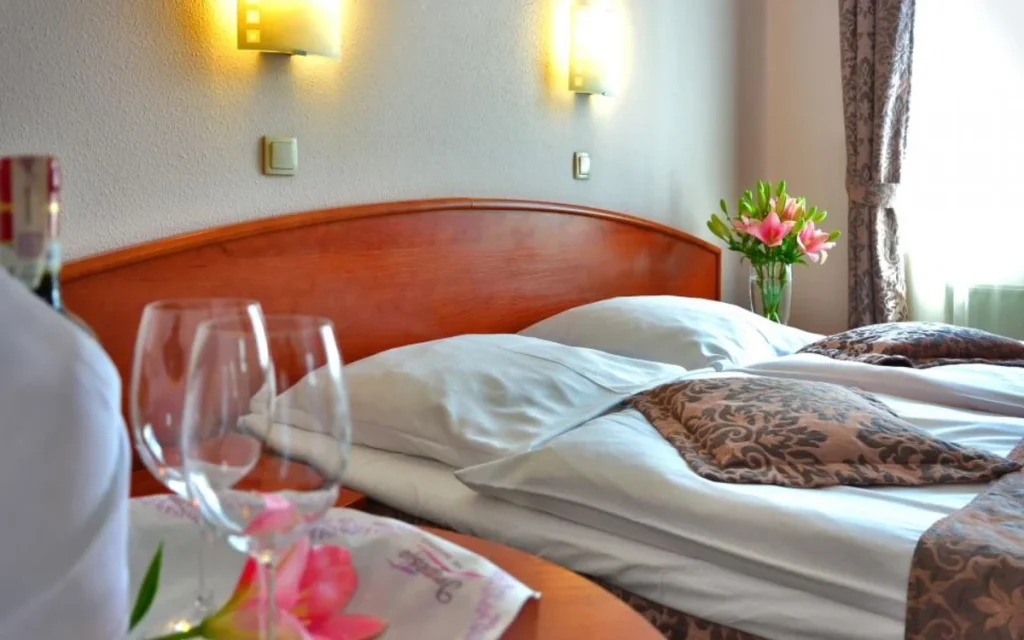 A hotel room with a made bed