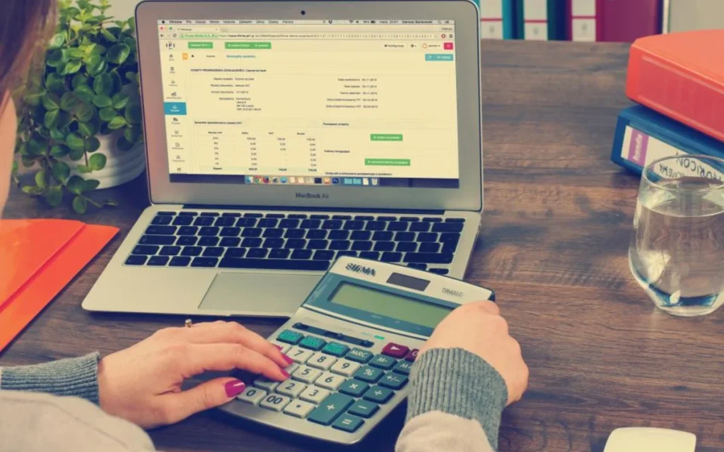Working through figures on a calculator and laptop