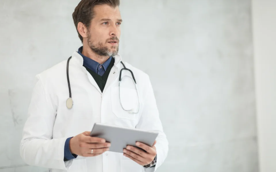 Doctor reviewing records on a tablet
