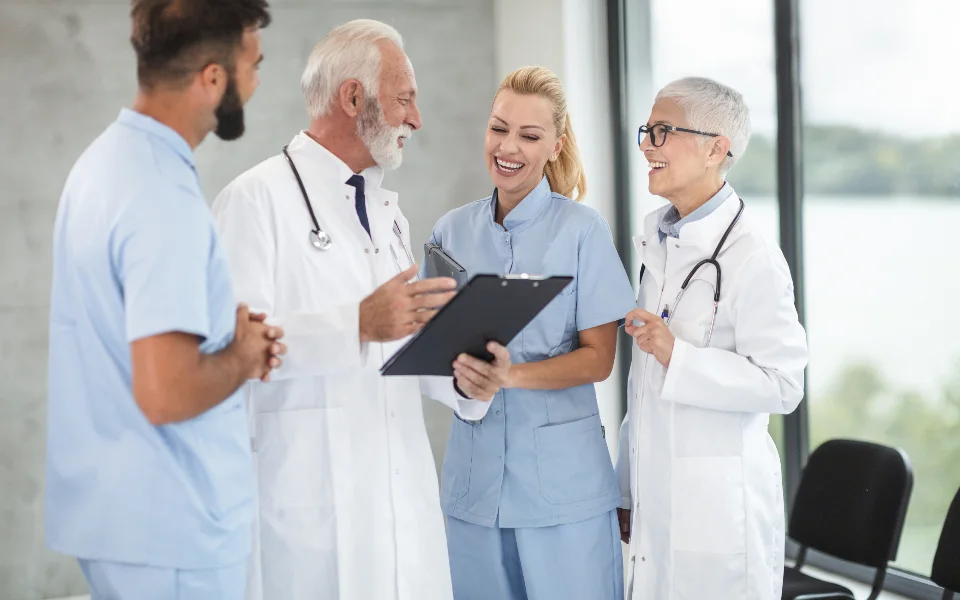 A medical team conferring over notes