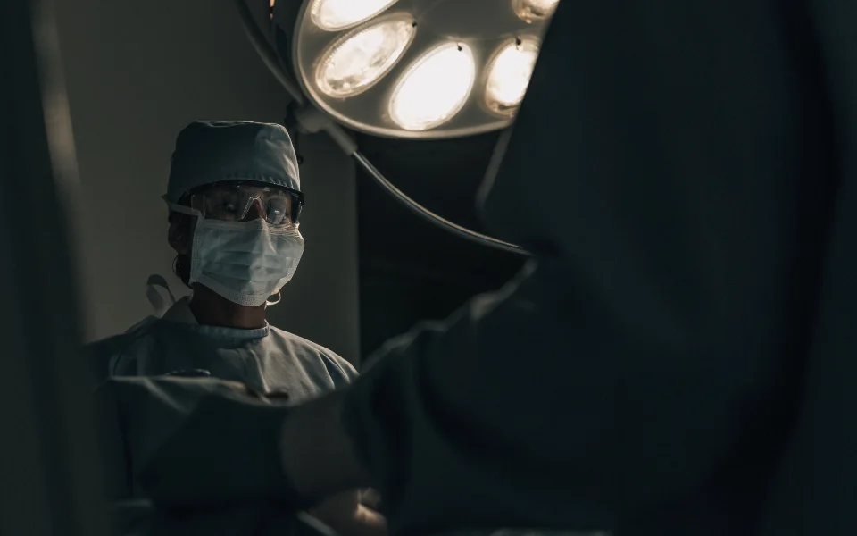Clinical team working under a theatre light