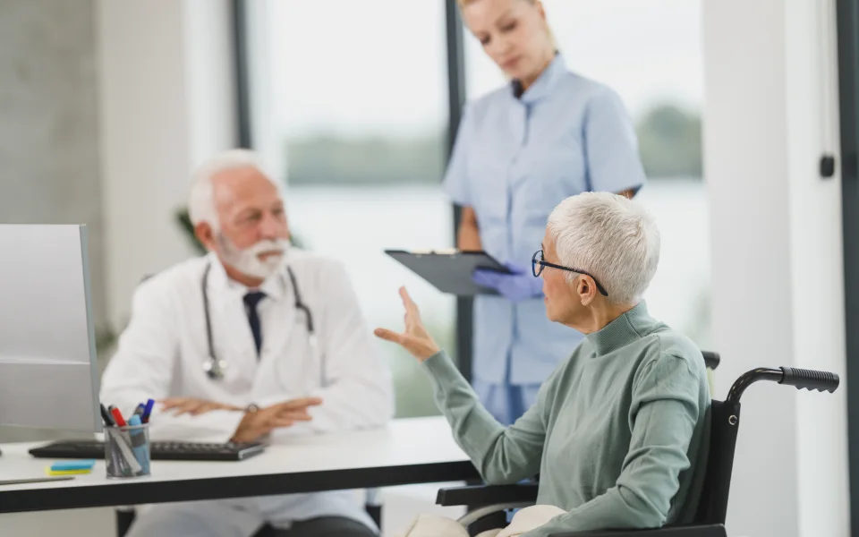 Doctor and nurse consulting with a patient