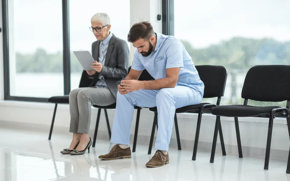 People waiting on chairs in a hospital waiting area